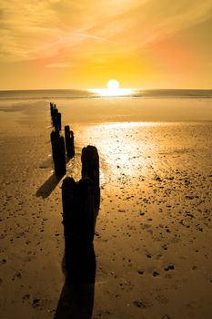 wave breakers at sunset on a golden beach in youghal county cork ireland