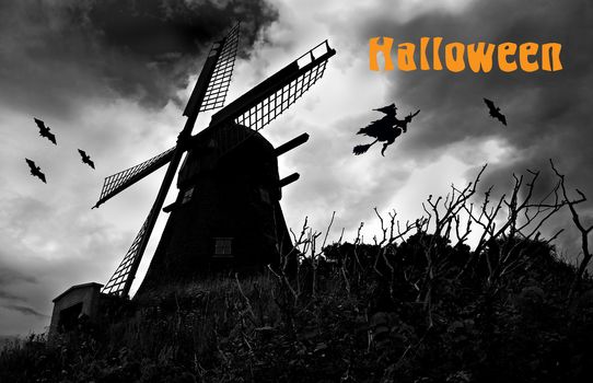 Halloween image with an old mill, bats and a witch