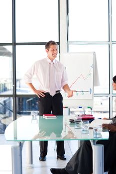 Attractive young businessman talking in a presentation