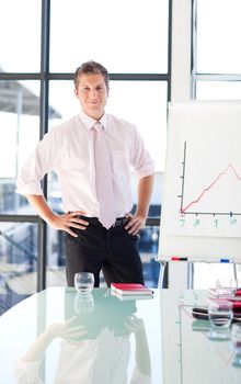 Attractive young businessman standing in a presentation