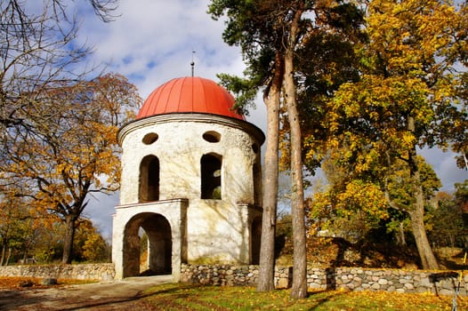 Old tower of manor on a background of autumn trees