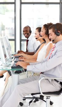 Ethnic businessman working in a call center with his colleagues