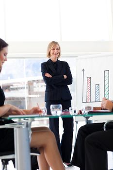 Mature businesswoman smiling at her team in a presentation