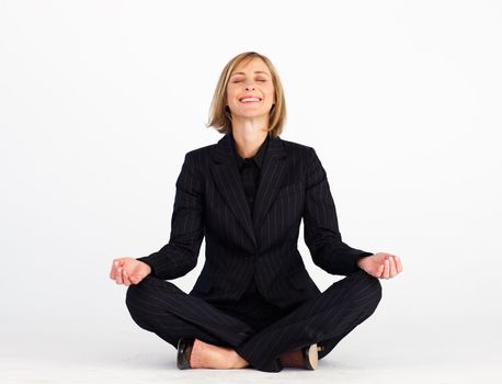 Smiling mature businesswoman doing yoga exercises