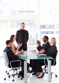 Business people applauding a young colleague in a presentation