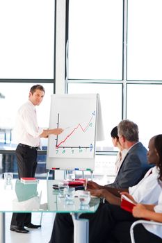 Businessman giving a presentation to his team in the office