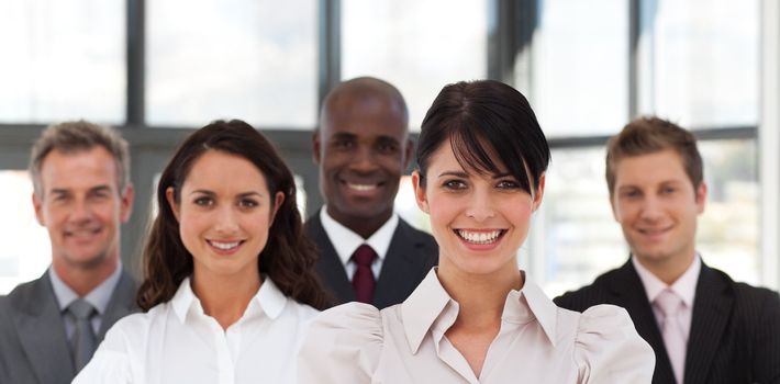 Cute business team standing together smiling at the camera 