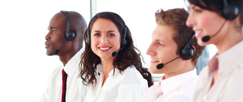 Smiling people with a headset on working in a call center 