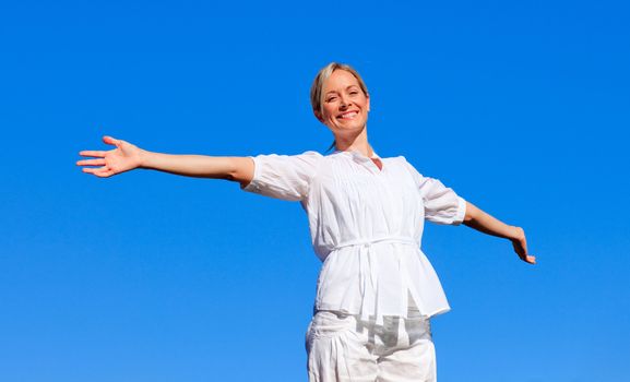 Young woman with open arms outdoors