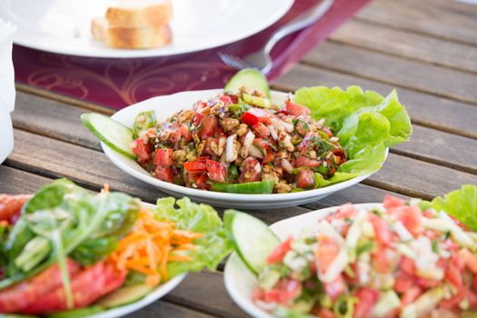 Walnut shepherd salad mixed with minced onions tomatoes, peppers, cucumbers and seasoned with olive oil and lemon juice.