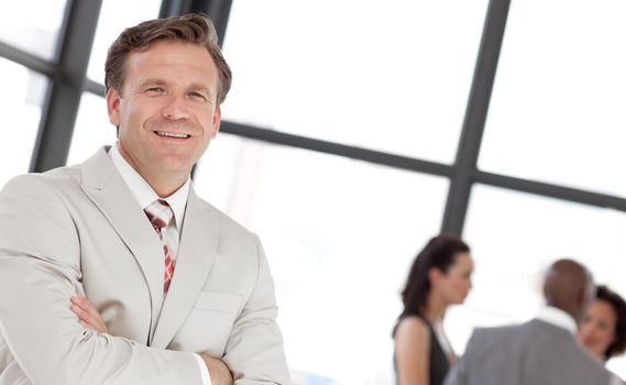 Portrait of a businessman with his team in the background
