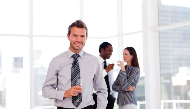 Happy young businessman in the office with his team