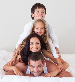 Happy family lying on their bed