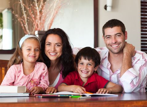 Nice parents helping their children for homework