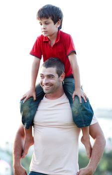 Father giving son piggyback ride outdoors