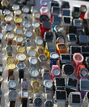 A group of many many wristwatches stand