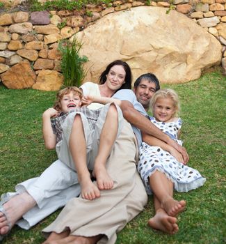 Smiling family resting in a garden