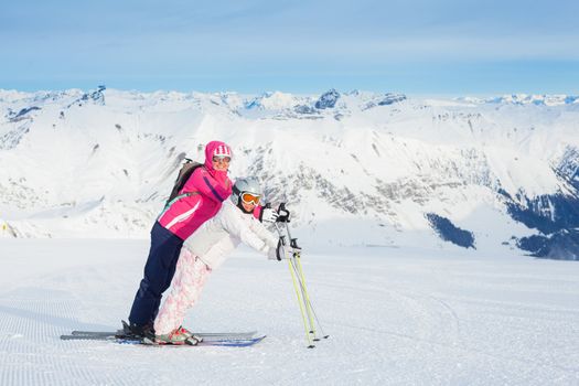 Happy smiling woman in ski goggles and with her daughter, Zellertal, Austria