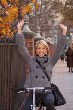 Young girl riding a city bike with no hands.