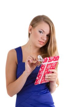 girl in a blue dress with long hair unpacks Christmas gift