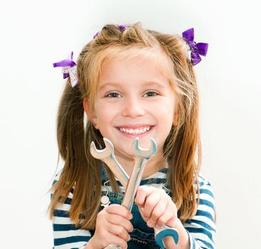 little smiling girl with a chrome spanners