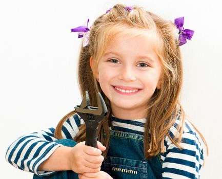 little smiling girl with a wrench