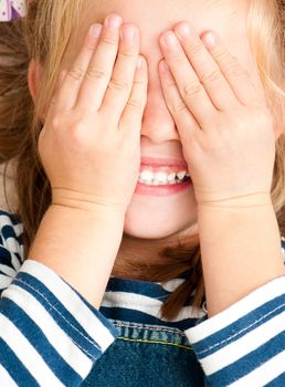 cute smiling girl with closed eyes by hands