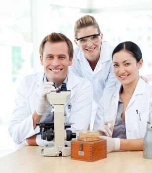 Young scientists working with a microscope in  a laboratory