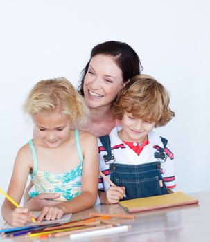 Happy children doing homework with their mother