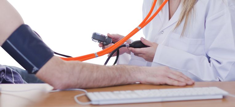 Doctor measuring blood pressure of a patient in clinic