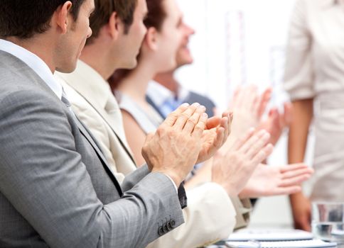 Portrait of a businessteam applauding during a meeting in the office 
