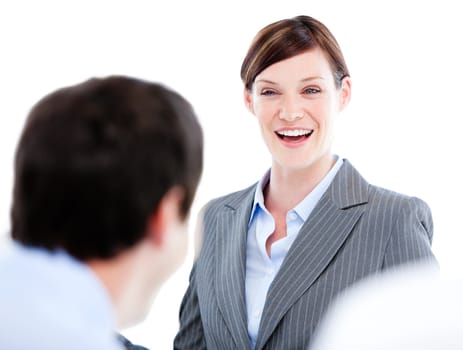 Portrait of a laughing businesswoman talking at her colleague during a meeting in the office 