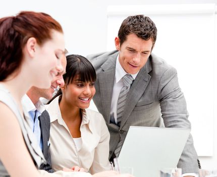 Portrait of a concentrated businesswoman working with her colleagues in the office