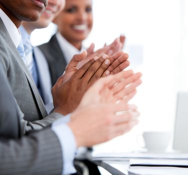 Close up of a  mixed business team applauding a presentation in the office