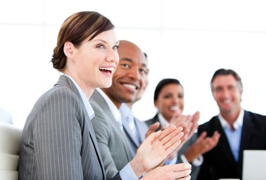Portrait of smiling businessteam applauding a presentation against a white background