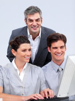 Enthusiastic businessteam working at a computer in the office