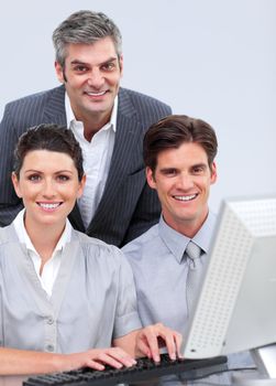 Successful business team working at a computer in the office
