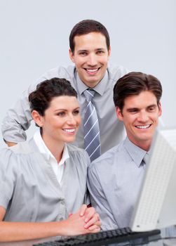 Positive businessteam working at a computer in the office