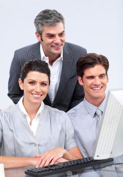 Charismatic businessteam working at a computer in the office