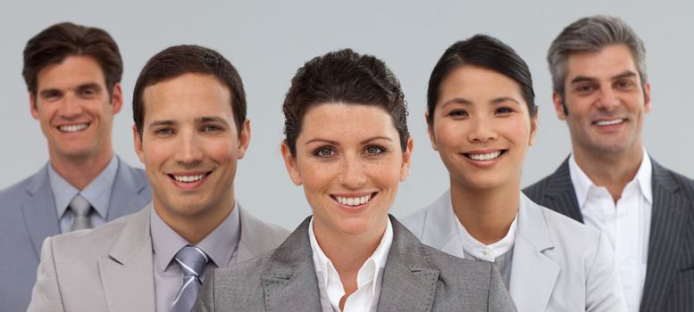 Business group showing diversity standing together in front of the camera