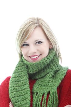 Smiling young blonde woman in a warm green knitted winter scarf isolated on white