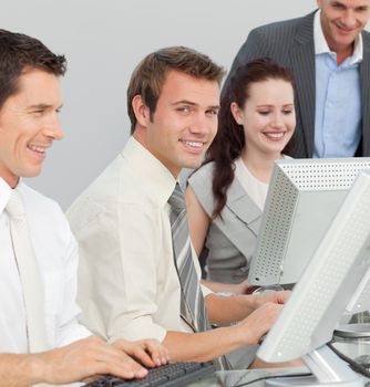 Young businessman and his colleagues working with computers in an office