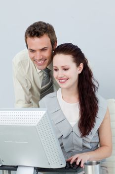 Attractive business people using a computer in the office