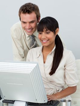 Attractive business people in the office using a laptop in the office