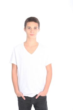 Serious young teenage boy standing with his hands in his pockets, three quarter portrait isolated on white
