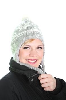 Closeup isolated portrait of a beautiful woman with radiant smile wearing a knitted cap with ear flaps for winter warmth Closeup facial portrait of a beautiful woman with radiant smile wearing a knitted cap with ear flaps for winter warmth