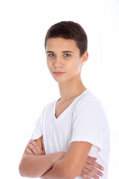 Serious teenage boy standing looking at the camera with folded arms isolated on white