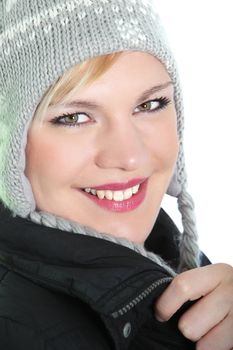 Closeup portrait of a lovely blonde girl with a beautiful smile wearing a knitted warm winter hat Closeup portrait of a lovely blonde girl with a beautiful smile wearing a knitted warm winter hat