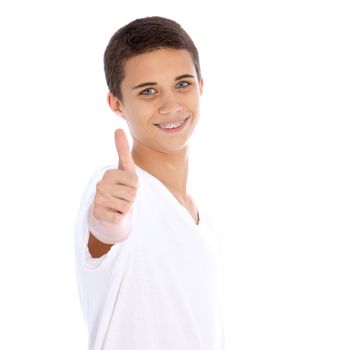 Smiling good looking young teenage boy giving a thumbs up of support and success isolated on white