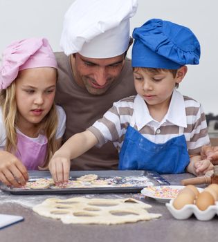 Portrait of father and children baking in the kitchen